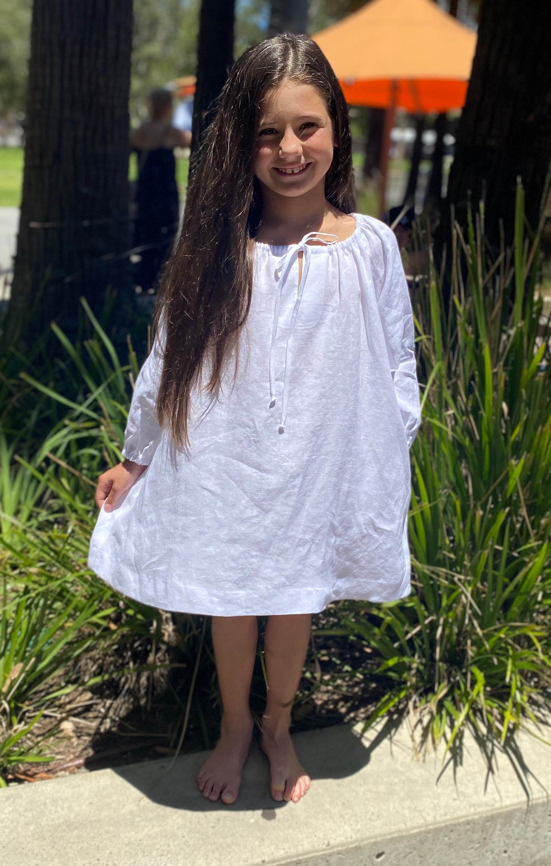 White smock dress with adjustable gathered neckline and pockets